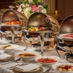 A luxurious buffet setup featuring polished stainless steel chafing dishes