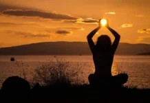 Holistic Well-Being: Your Path to a Balanced Life A serene nature scene with a woman meditating featuring Holistic Health & Well-Being