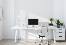 A sleek, Minimalist Office Organization with a clean white desk, ergonomic chair, neatly arranged workspace essentials, soft lighting, and a touch of greenery.
