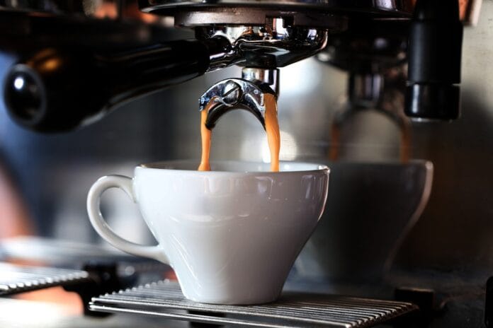 A futuristic AI-powered coffee machine on a marble kitchen counter