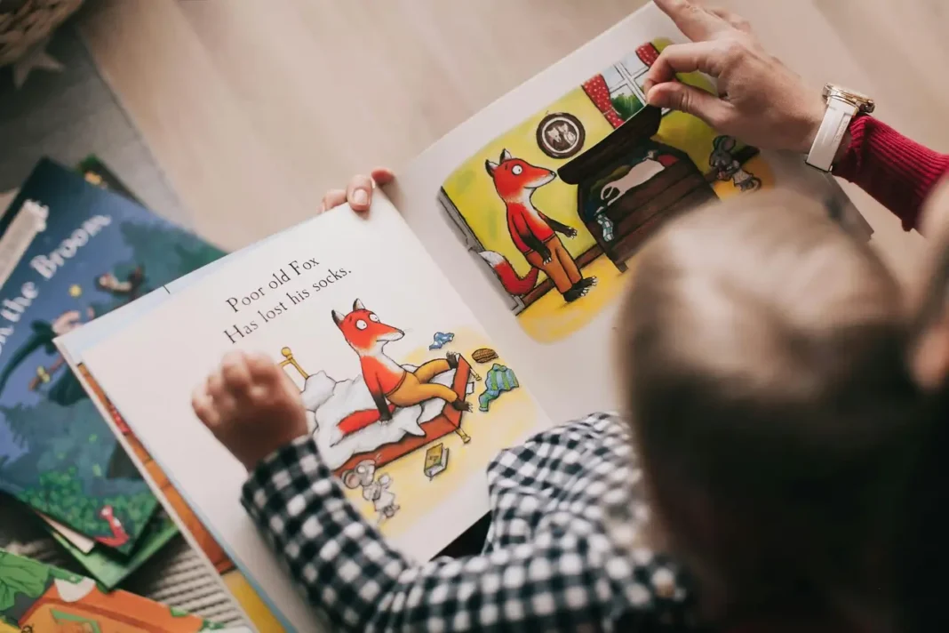 A joyful preschool teacher reading a colorful picture book to a diverse group of attentive toddlers in a cozy classroom reading nook featuring early literacy