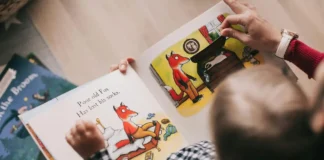 A joyful preschool teacher reading a colorful picture book to a diverse group of attentive toddlers in a cozy classroom reading nook featuring early literacy