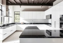 A modern kitchen with sleek black granite worktops