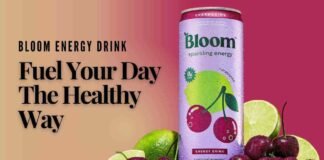 A sleek can of Bloom Energy Drink surrounded by fresh fruits
