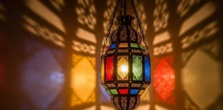 A luxurious Moroccan-style hanging lantern glowing warmly in a cozy living room