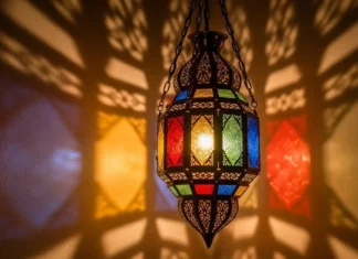Moroccan Style Hanging Lanterns for Elegant Homes A luxurious Moroccan-style hanging lantern glowing warmly in a cozy living room