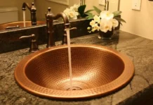 Elegant Hammered Copper Sinks for Lasting Beauty (Why They Shine) luxury kitchen featuring a hammered copper sink
