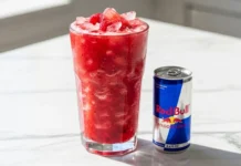 red bull fruit smoothie made with fresh berries and ice in a clear glass