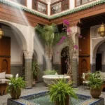 Luxury boutique riad courtyard in Fes with traditional Moroccan design and fountain