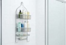 Modern hanging shower caddy with toiletries in a clean white bathroom