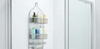 Modern hanging shower caddy with toiletries in a clean white bathroom