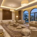 Modern majlis seating with elegant Arabic floor seating, luxury sofas, neutral cushions, and contemporary Middle Eastern interior design.