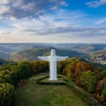 The Christ of the Ozarks statue standing atop Magnetic Mountain overlooking the forests of Eureka Springs, Arkansas.