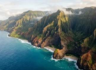 Best Things to Do in Kauai: 15 Unforgettable Experiences Nā Pali Coast cliffs rising above the turquoise Pacific Ocean in Kauai.