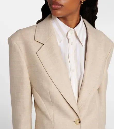 Close-up of tailored blazer fabric, clean stitching, and a cotton shirt cuff