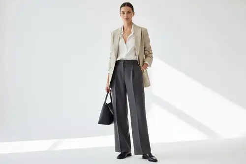 Twelve neutral workwear essentials arranged into a minimalist capsule wardrobe